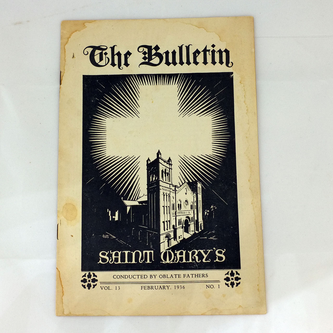 Cover of The Bulletin, St. Mary’s, volume 13 no. 1, February 1936, church tower and sunburst cross, aged paper