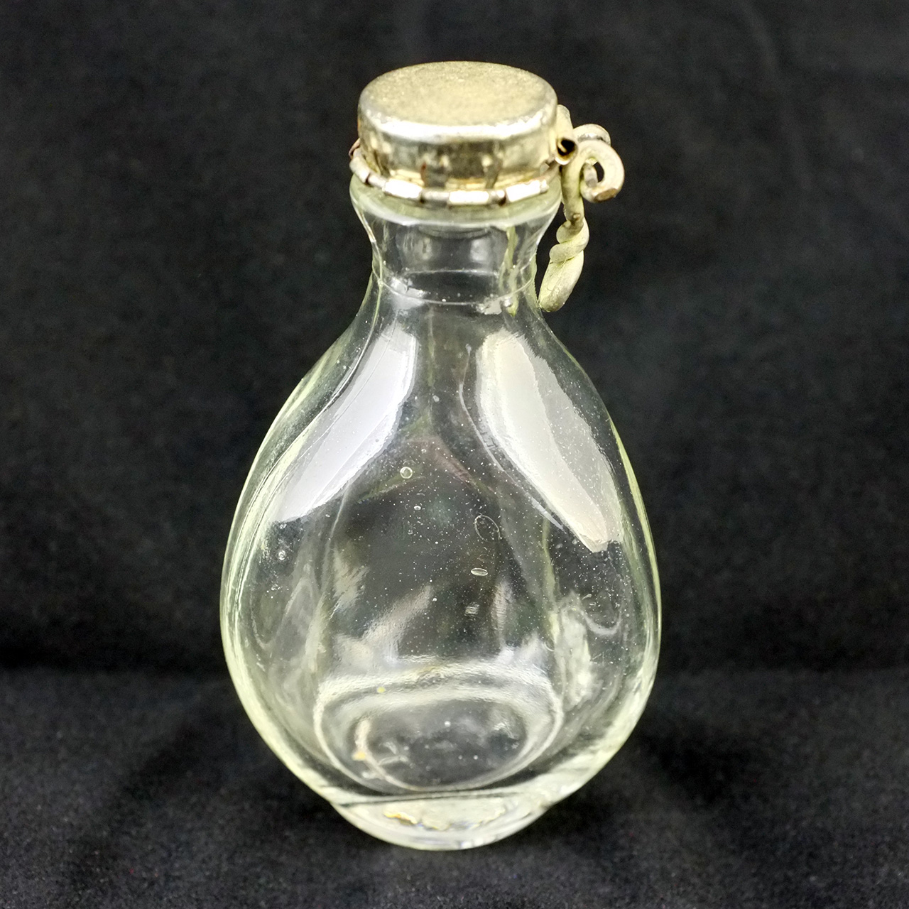 Triangular glass bottle with Kork-N-Seal-style cap; embossed letters on base may be Haig and Haig or Hoffmann-Hayman