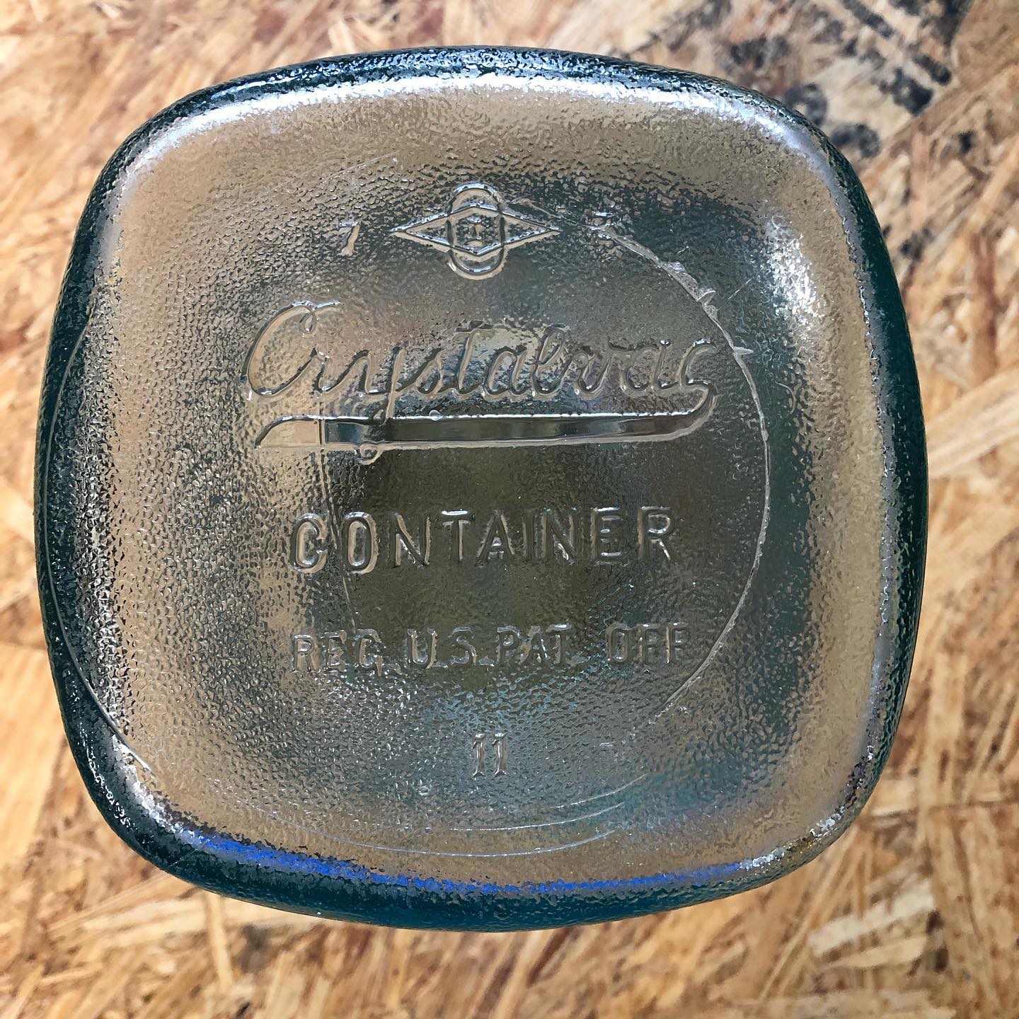Base of the jar: "Crystalvac CONTAINER / REG. U.S. PAT. OFF / II" with the Owens-Illinois maker's mark