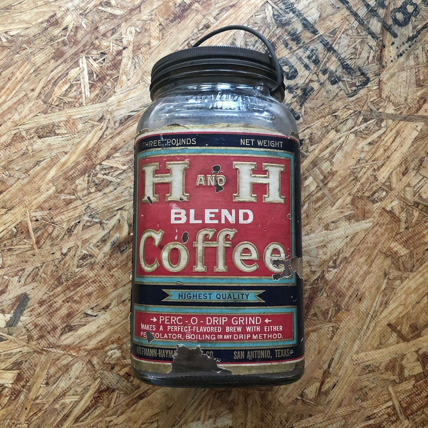 Three-pound H and H Blend Coffee glass jar with paper label: "Highest Quality / Perc-O-Drip Grind / Hoffmann-Hayman San Antonio Texas" and the reverse showing coffee pot illustration with "We Roast It, Others Praise It".