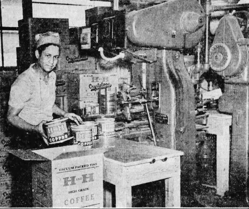 Plant photo crop showing H and H worker at the newly installed vacuum closing machine with a stack of H-H Coffee shipping cartons, The News, 3 Nov 1937