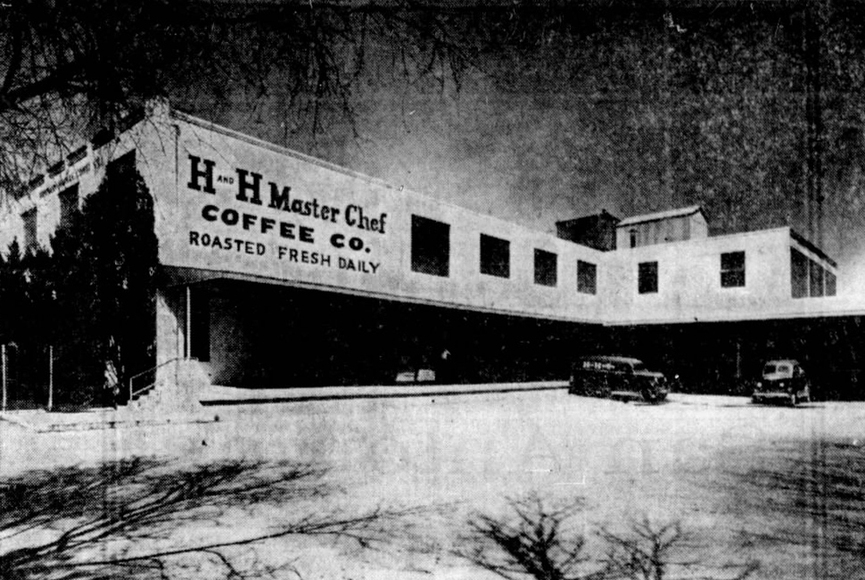 Two-story plant facade with large lettered sign — H AND H Master Chef, COFFEE CO., ROASTED FRESH DAILY; parking area and period vehicles below