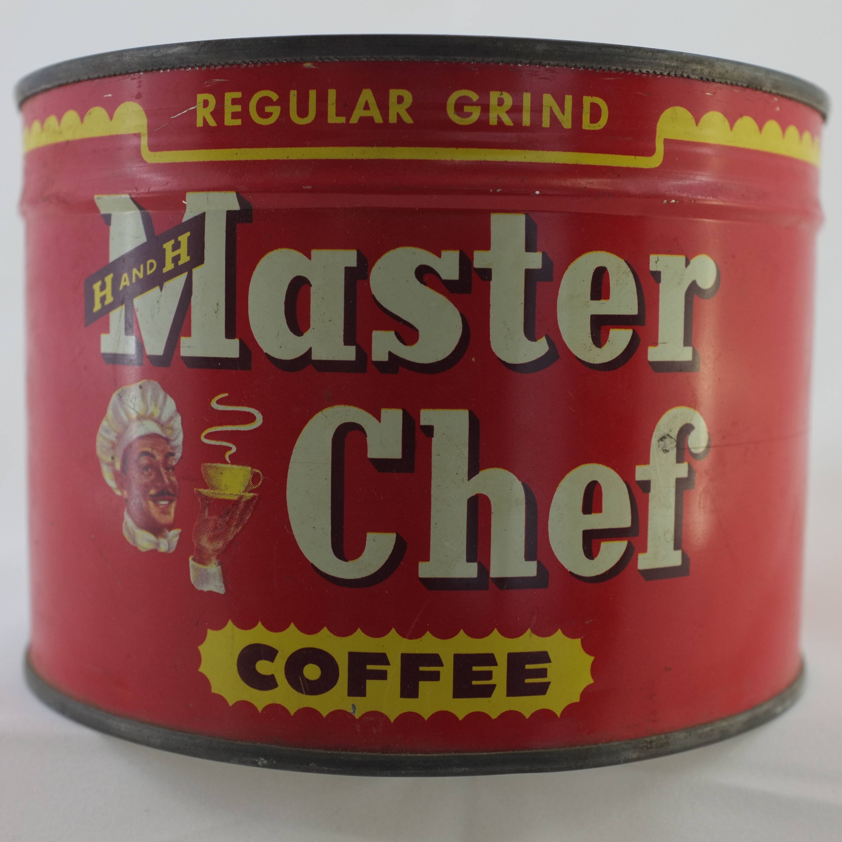 Red Master Chef Regular Grind coffee tin, H AND H banner, chef portrait, yellow COFFEE burst, studio white background