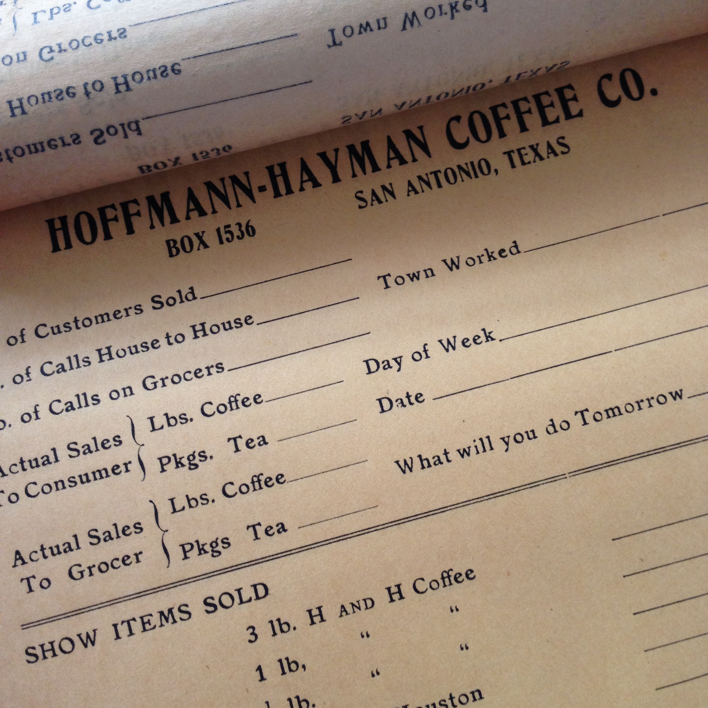 Stack of Hoffmann–Hayman sales report booklets, interwar handwritten forms, shop-worn paper