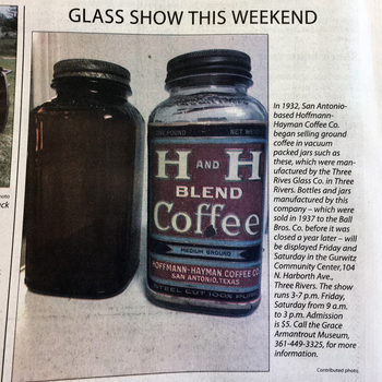 **iPhone photograph** of a **newspaper clipping** from ***The Progress*** (**Three Rivers, Texas**) — **below the fold** on the **front page**, headline **GLASS SHOW THIS WEEKEND**, **Contributed photo** showing **amber** and **clear** one-pound **H and H Blend** **Crystalvac** jars side by side; adjacent article summarizes **Hoffmann-Hayman** **1932** vacuum-pack jars from **Three Rivers Glass Co.**, **1937** Ball Bros. sale, weekend hours at **Gurwitz Community Center** (**104 N. Harborth Ave.**), **$5** admission, and **Grace Armantrout Museum** contact — the **clear labeled jar** is the **Mac Johanson / Austin** specimen — **press documentation**, **not** an object in the San Antonio museum collection