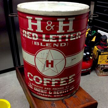 Large cylindrical vintage coffee tin — **red** shell with white **H & H** wordmark, arched **RED LETTER** and **(BLEND)**, central roundel with star and **H**, **COFFEE** in block serif; base band *Roasted and Packed by the **Harnit & Hewitt Co. Toledo, Ohio*** — unrelated **H & H** initial collision with Hoffmann-Hayman San Antonio; friction lid with bail ears; workshop background.