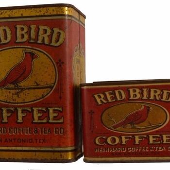 Two rectangular lithographed **Red Bird Coffee** tins — maroon field, arched **RED BIRD** wordmark, cardinal on a branch in an oval, **COFFEE** block type; base reads **REINHARD COFFEE & TEA CO.** / **SAN ANTONIO, TEX.** — contemporary San Antonio roaster packaging, **not** Hoffmann-Hayman H and H; taller tin left, shorter wide tin right; rust and wear. See [Red Bird one-pound tin](/red-bird-coffee-tin-one-pound/).